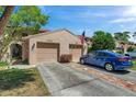 Charming townhouse featuring a two-car garage, landscaped yard, and inviting curb appeal at 4733 W Vasconia St, Tampa, FL 33629