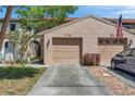 Charming townhouse featuring a two-car garage, landscaped yard, and inviting curb appeal at 4733 W Vasconia St, Tampa, FL 33629