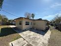 Rear view of a home featuring a door to the backyard and a neutral color scheme at 4911 Largo Ter, New Port Richey, FL 34652