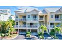 Beautiful pastel-colored townhouse with balconies, manicured landscaping, and covered parking at 525 Bahia Beach Blvd, Ruskin, FL 33570