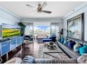 Stylish living room featuring modern furniture, dark hardwood floors, and a sliding glass door at 525 Bahia Beach Blvd, Ruskin, FL 33570