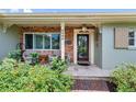 Charming front porch featuring brick accents, comfortable seating, and a decorative front door at 8300 37Th N Ave, St Petersburg, FL 33710