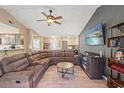 Open-concept living room featuring a sectional sofa and entertainment center, perfect for relaxing and entertaining at 8421 Unity Dr, Port Richey, FL 34668