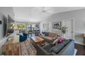 Bright living room with neutral walls, a vaulted ceiling, a ceiling fan and lots of comfortable furniture at 921 Lynnlea Ln, Tarpon Springs, FL 34689