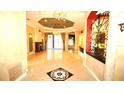 Spacious foyer with tile flooring, chandelier, and intricate architectural details at 9460 Bearfoot Trl, Weeki Wachee, FL 34613