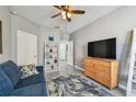 Inviting living room featuring a large flat-screen TV, comfortable seating, and a decorative area rug at 10442 Villa View Cir, Tampa, FL 33647