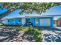 Charming single-story home with a well-maintained lawn and a vibrant blue exterior at 13970 Montego Dr, Seminole, FL 33776