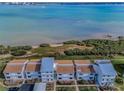 Coastal townhouses with pristine waterfront views showcase the community's picturesque setting and serene lifestyle at 1451 Gulf Blvd # 207, Clearwater Beach, FL 33767