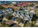 Lovely aerial view of townhome with lush landscaping, a tennis court, and well-maintained surroundings at 14723 Seminole Trl, Seminole, FL 33776