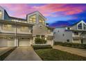 Stylish townhouse featuring an attached garage, modern architectural details, and manicured landscaping at 14723 Seminole Trl, Seminole, FL 33776