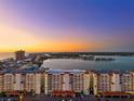 Overhead view of a waterfront condo complex near a bay, showcasing its location and architecture at 17717 Gulf Blvd # 702, Redington Shores, FL 33708