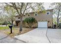 Attractive two-story home featuring stone accents, well-placed palm trees, and a convenient attached garage at 18914 5Th St, Lutz, FL 33548