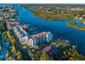 Aerial view of the Vista Bay condo on a waterway offering a tennis court, boat docks, and beautiful landscaping at 19111 Vista Bay Dr # 304, Indian Shores, FL 33785