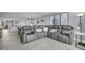 Relaxing living room with a large gray sectional, neutral paint, and modern decorations for a comfortable living space at 19111 Vista Bay Dr # 304, Indian Shores, FL 33785