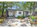 Inviting single-story home with a covered carport, a well-maintained lawn, and a brick exterior at 3202 W Coachman Ave, Tampa, FL 33611