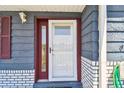 Close-up of the home's front door, showcasing the entrance with sidelight and hardware at 3257 Masonville Loop, Holiday, FL 34691