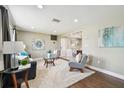 Inviting living room featuring hardwood floors, recessed lighting, and neutral paint colors at 3257 Masonville Loop, Holiday, FL 34691