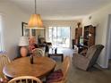 Spacious living room area with patio access, wood dining table, and cozy furnishings at 337 Woodlake Wynde, Oldsmar, FL 34677