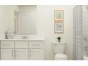 Bright bathroom featuring a clean vanity, modern fixtures, and a stylish shower curtain at 36023 Joseph Blake St, Zephyrhills, FL 33541