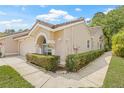 Beautiful angle view of the home with desert landscaping, neutral stucco exterior and a charming barrel tile roof at 3810 Darston St, Palm Harbor, FL 34685