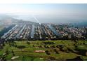 An aerial view of a waterfront community surrounded by golf course, showing numerous boats docked behind the homes at 3901 E Eden Roc Cir, Tampa, FL 33634