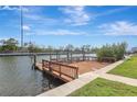 Beautiful waterfront dock with wood railings and expansive deck overlooking calm waters and green space at 3901 E Eden Roc Cir, Tampa, FL 33634