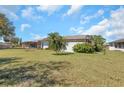 Expansive backyard with lush greenery and view of a screened patio of this inviting property at 4534 Great Lakes S Dr, Clearwater, FL 33762