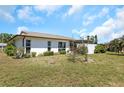 View of the spacious backyard, showcasing the home's exterior features and landscaping at 4534 Great Lakes S Dr, Clearwater, FL 33762