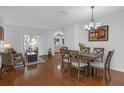 Bright dining room featuring hardwood floors, neutral paint, and access to the backyard at 5634 Tanagergrove Way, Lithia, FL 33547