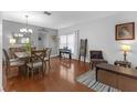A living room featuring hardwood floors, neutral paint, and stylish furniture at 5634 Tanagergrove Way, Lithia, FL 33547