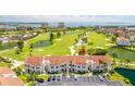 Golf course community featuring lush landscaping, ponds, and residential buildings with red tile roofs at 6131 Bahia Del Mar Blvd # 240, St Petersburg, FL 33715
