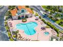 Aerial view of a community pool and hot tub, surrounded by lounge chairs and manicured landscaping at 6131 Bahia Del Mar Blvd # 240, St Petersburg, FL 33715