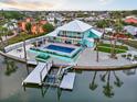 Aerial view showcasing a waterfront home with a pool, boat dock, and manicured outdoor space at 744 Spanish Main Dr, Apollo Beach, FL 33572