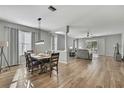 Open-concept living area with hardwood floors and plentiful natural light at 7740 Blue Spring Dr, Land O Lakes, FL 34637