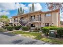 Condo exterior with stone facade and landscaped grounds at 9910 Eagles Point Cir # 3, Port Richey, FL 34668