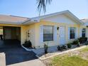 Inviting single-story home featuring yellow siding, white trim, and a well-maintained lawn at 1012 Warwick Ct, Sun City Center, FL 33573