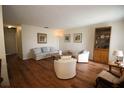 Cozy living room featuring hardwood floors, comfortable seating, and natural light at 1012 Warwick Ct, Sun City Center, FL 33573
