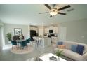 Open-concept living space featuring a modern kitchen, dining area, and comfortable seating at 1038 Ocean Spray Dr, Ruskin, FL 33570