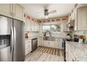 Modern kitchen with stainless steel appliances, updated cabinets, and granite countertops at 10517 Blossom Lake Dr, Seminole, FL 33772