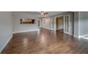 Spacious living room boasts wood floors, neutral paint, and ample natural light at 1536 Alamo Ln, Dunedin, FL 34698