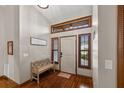 Welcoming foyer with hardwood floors, a decorative bench, and natural light through sidelight windows at 1916 38Th W St, Bradenton, FL 34205