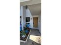 Inviting front entrance featuring a decorative potted plant arrangement and a warm-toned front door at 1960 Lakewood Club Dr S # 2-F, St Petersburg, FL 33712