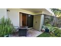 Cozy patio area with sliding glass doors, a storage unit, and a small decorative table at 1960 Lakewood Club Dr S # 2-F, St Petersburg, FL 33712