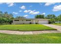 Traditional single-story home with a well-kept lawn and attached two-car garage at 2216 El De Oro Dr, Clearwater, FL 33764
