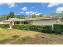 Charming home featuring a neatly maintained lawn and privacy hedges near the front entrance at 2216 El De Oro Dr, Clearwater, FL 33764