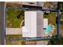 Aerial view of the property showcasing the pool in the fenced in backyard and surrounding greenery at 2972 E Vina Del Mar Blvd, St Pete Beach, FL 33706