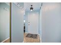 Bright hallway with light blue walls, hardwood floors, and coat rack at 3585 41St S Ter # 227, St Petersburg, FL 33711