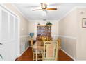 Bright dining room with hardwood floors, complemented by a ceiling fan and classic china cabinet display at 4022 Lighthouse Way, New Port Richey, FL 34652