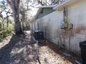 Exterior side view of the home showing the AC unit and electrical box at 4405 Coconut Cove Pl, Valrico, FL 33596