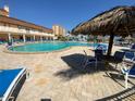 Large outdoor pool with lounge chairs and shade structures for relaxing and enjoying the sun at 5020 Brittany S Dr # 212, St Petersburg, FL 33715
